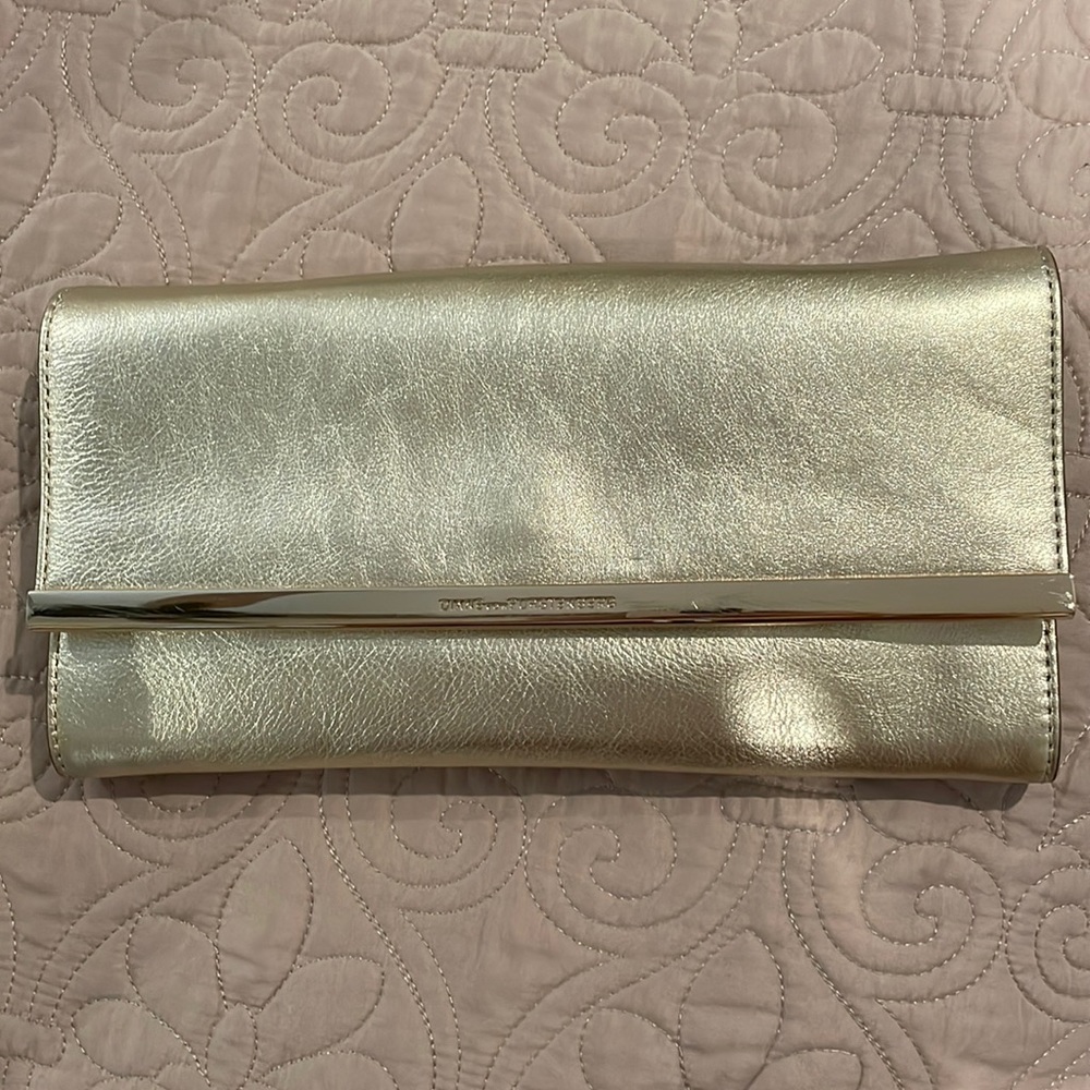 Diane VonFurstenberg gold bag with gold chain.